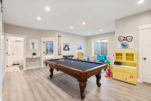 Recreation room featuring light wood-type flooring and billiards