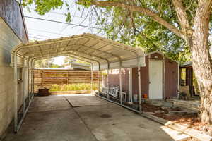 View of vehicle parking featuring a carport