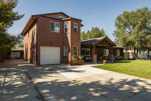 View of front of property with a garage and a front yard