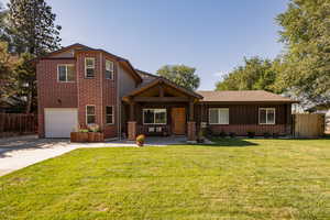 View of front of house with a front yard and a garage