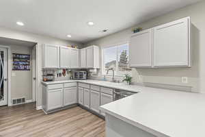 Kitchen with white cabinetry and sink