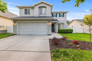 Front of property featuring a front lawn and a garage