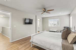 Bedroom with ceiling fan and light hardwood / wood-style floors