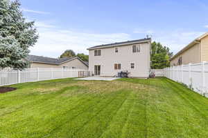 Back of property with a patio area and a yard