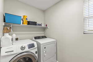 Washroom with separate washer and dryer and a wealth of natural light