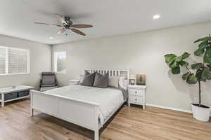 Bedroom with ceiling fan and light wood-type flooring