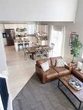 Living room featuring light hardwood / wood-style floors and a notable chandelier