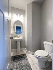 Bathroom with tile patterned flooring and toilet