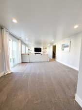 Unfurnished living room with carpet floors