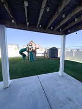 View of patio / terrace featuring a storage unit and a playground