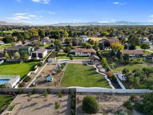 Arial view shows walk path, playground, pavilion, basketball court, sheds and so much more. Facing South.