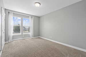 Empty room featuring carpet and a textured ceiling