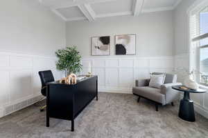 Office area with beam ceiling, crown molding, and light colored carpet