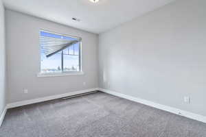 Carpeted spare room featuring a textured ceiling