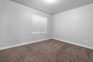 Empty room with carpet floors