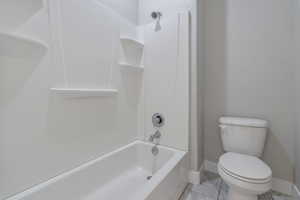 Bathroom with tub / shower combination and toilet