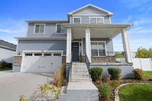 View of front of home featuring a porch and a garage