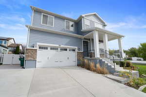 View of front of property featuring a porch and a garage