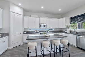 Kitchen featuring white cabinetry, stainless steel appliances, and sink