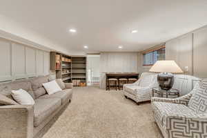 Basement living room with built-in bookshelves