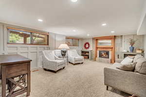 Basement living room with a tile fireplace