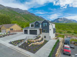View of front facade featuring a mountain view and a garage