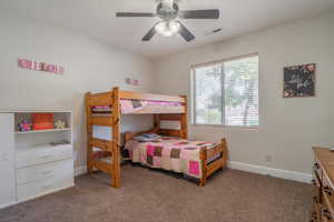 Bedroom featuring ceiling fan and carpet