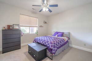 Carpeted bedroom with ceiling fan