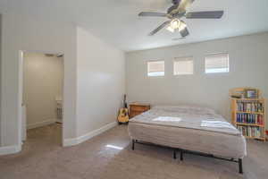 Carpeted bedroom with ceiling fan