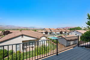 Wooden deck featuring a fenced in pool and a mountain view