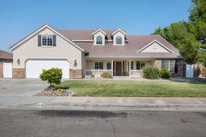 View of front facade featuring a front lawn and a porch