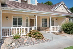 Entrance to property featuring covered porch