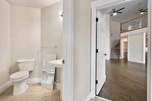 Bathroom featuring hardwood / wood-style floors and toilet