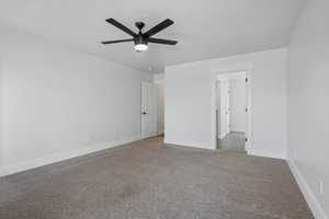 Unfurnished bedroom with ceiling fan and carpet floors