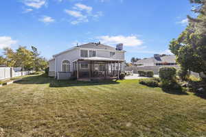 Rear view of property featuring a gazebo and a yard