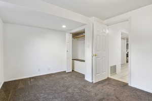 Unfurnished bedroom with a closet and light colored carpet