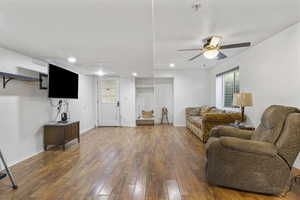 Living room featuring dark hardwood / wood-style floors and ceiling fan