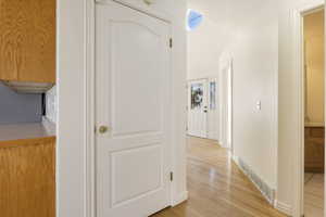 Corridor with light wood-type flooring