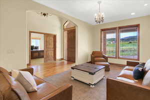 Living room with an inviting chandelier and light hardwood / wood-style floors