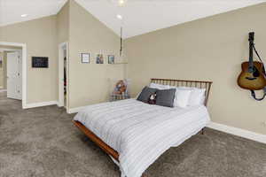 Upstairs North Bedroom Carpeted bedroom with high vaulted ceiling