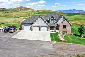 View of front facade featuring a front lawn and a mountain view