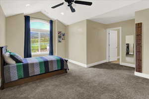 Upstairs South Bedroom Carpeted bedroom with ceiling fan and vaulted ceiling