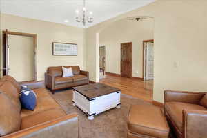 Living room featuring hardwood / wood-style floors and an inviting chandelier