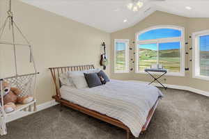 Upstairs North Bedroom Carpeted bedroom featuring ceiling fan and lofted ceiling