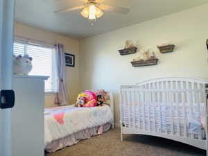 Second Bedroom with carpet floors and ceiling fan