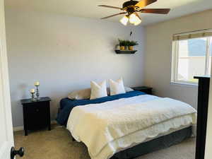 Maste Bedroom featuring ceiling fan and light carpet