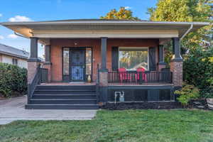 Exterior space with a front yard and a porch