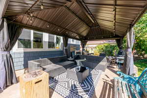 View of patio featuring a gazebo and an outdoor hangout area