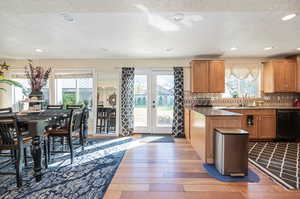 Kitchen featuring black dishwasher, sink, and plenty of natural light