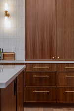 Cabinet space with light stone counters and tasteful backsplash